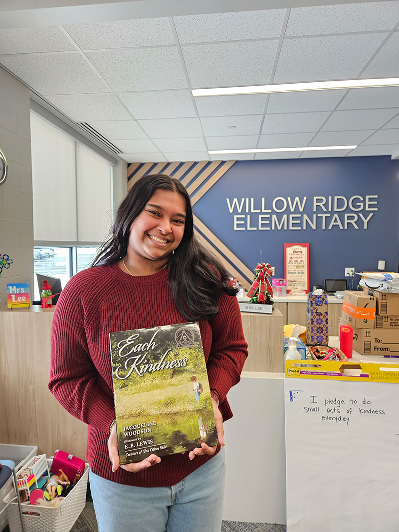 Maansi presenting books and kindness materials at Willow Ridge Elementary School